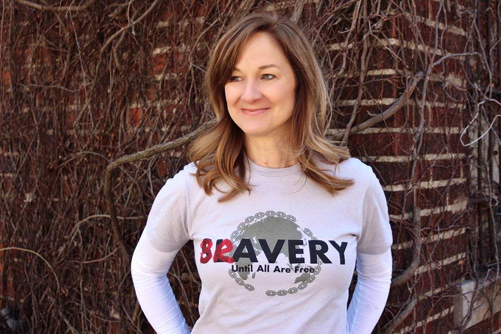 Woman standing in front of the brick wall