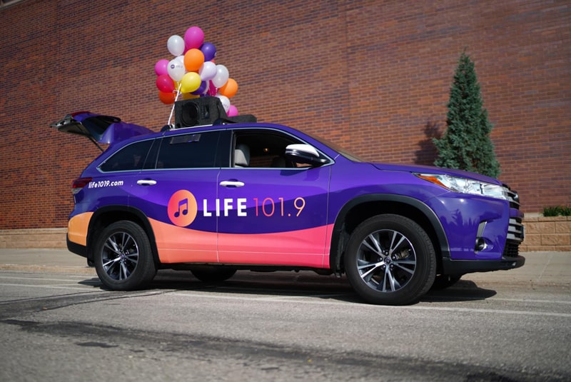 A car in the colors and logo of Life 101.9