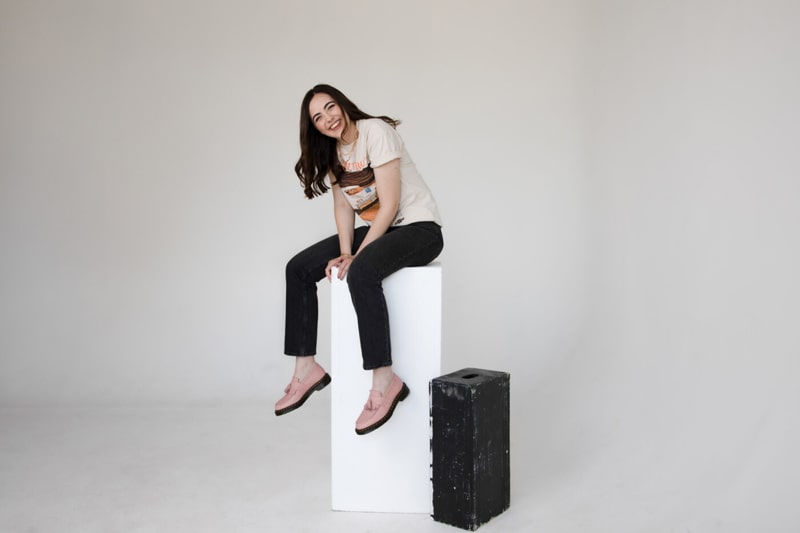 Natalie Layne sitting on the white box