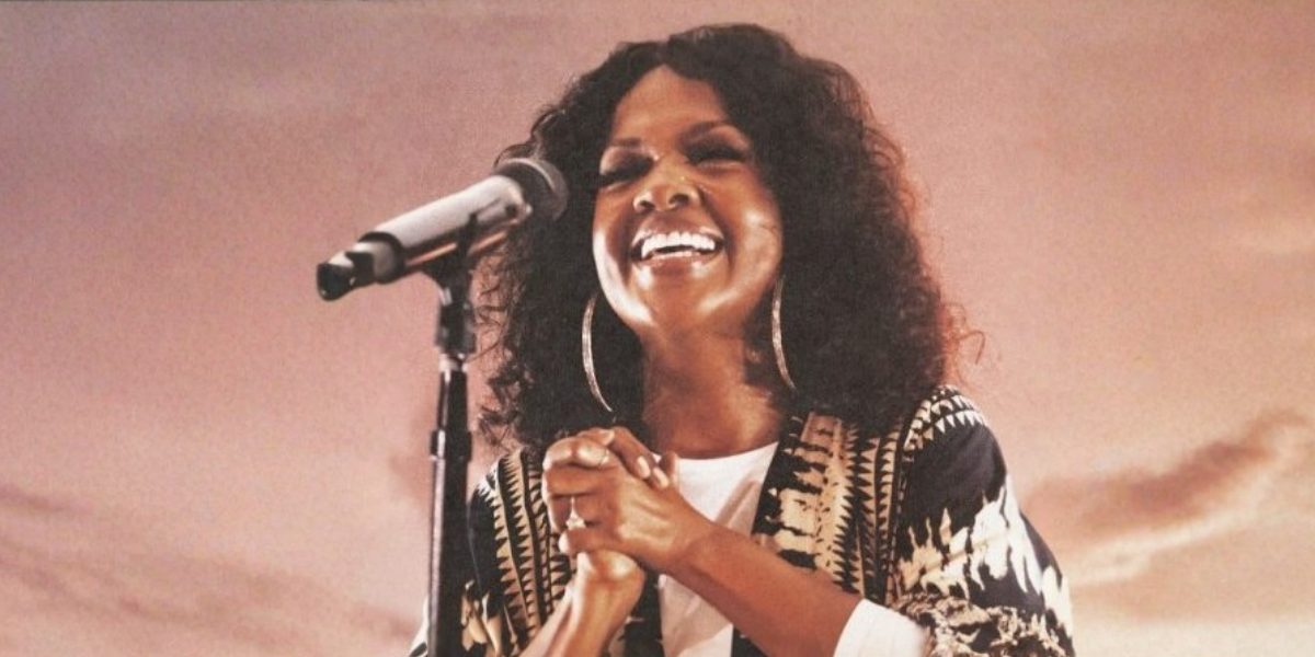 Cece Winans smiling as she sings